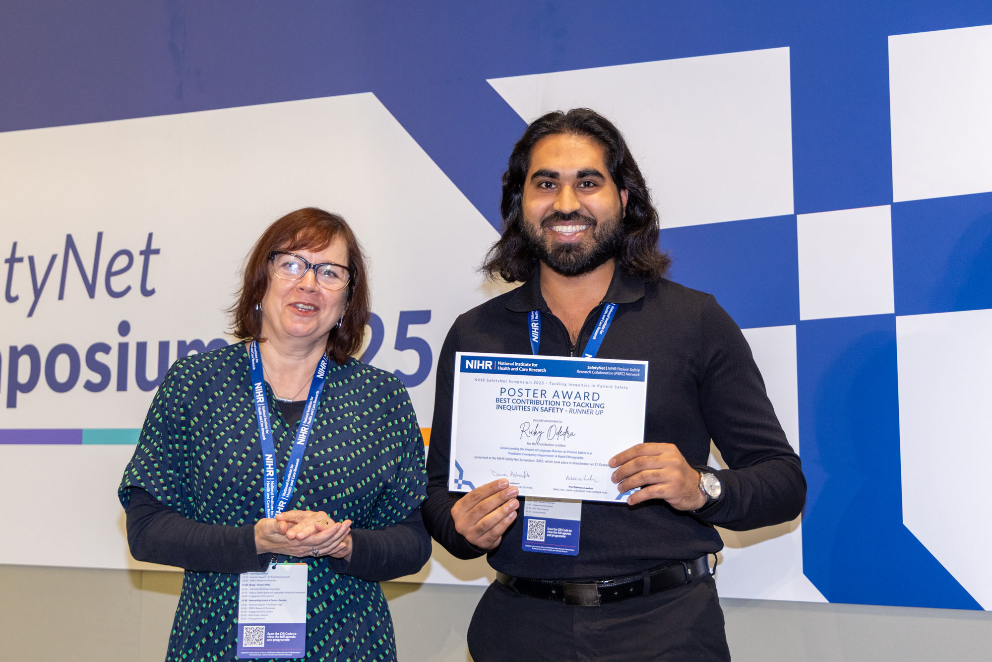 Ricky Odedra receiving the award from the chair, Prof Rebecca Lawton