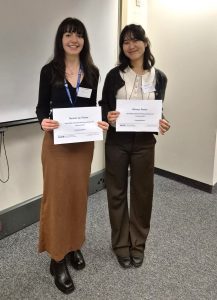 Lauren and Victoria receive their certificates.
